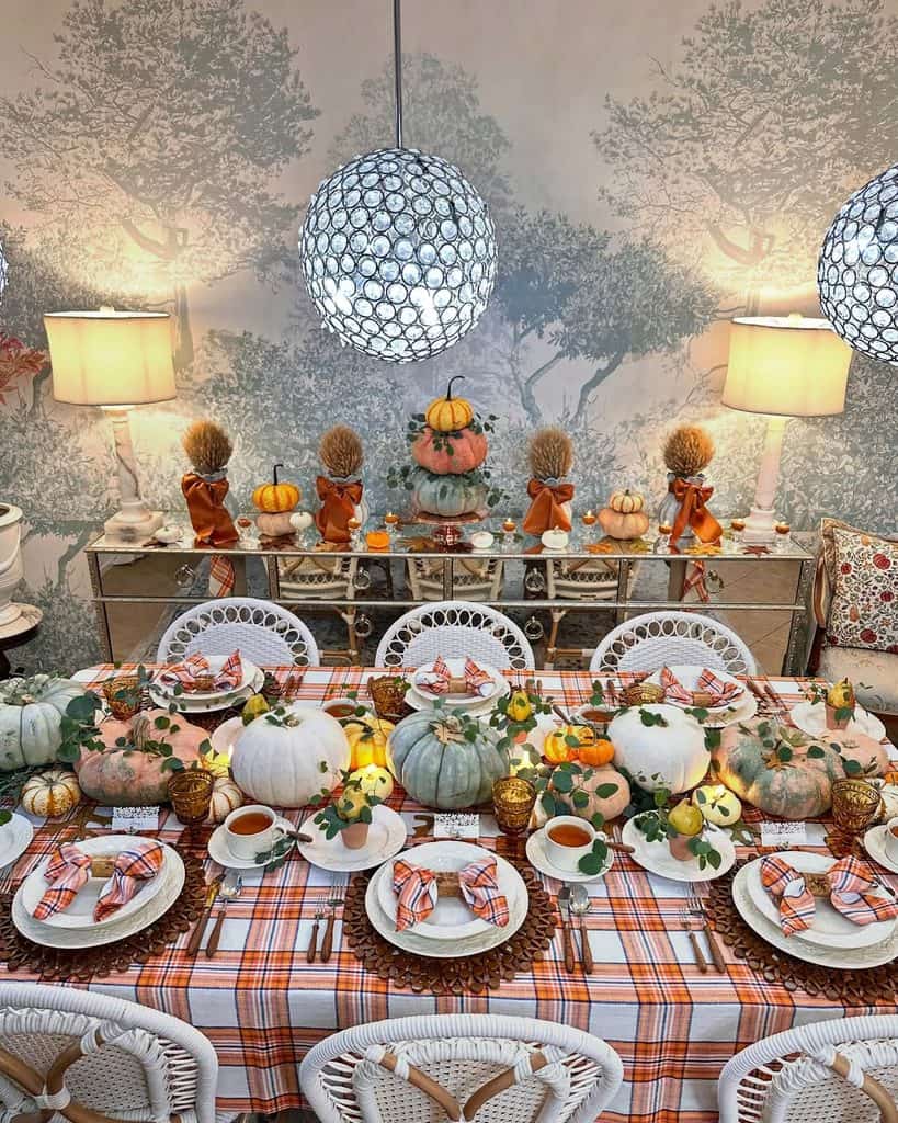 Autumn-themed table setting with pumpkins, gourds, and fall accents.