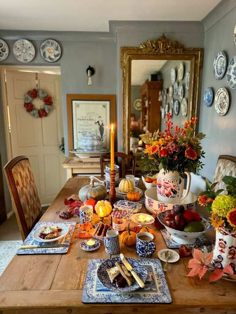 Decorative fall table with pumpkins, flowers, and seasonal accents for autumn decor.