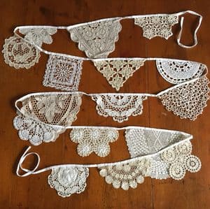 String of vintage white lace doilies used as a decorative garland.