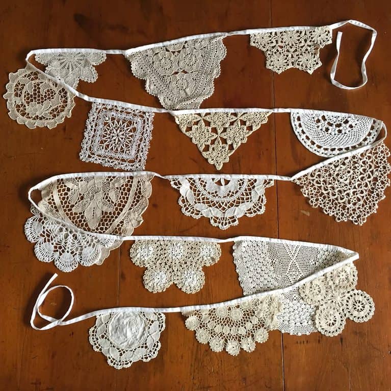 String of vintage white lace doilies used as a decorative garland.