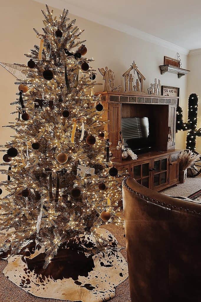 Festive Christmas tree with ornaments and lights in a warm living room setting.