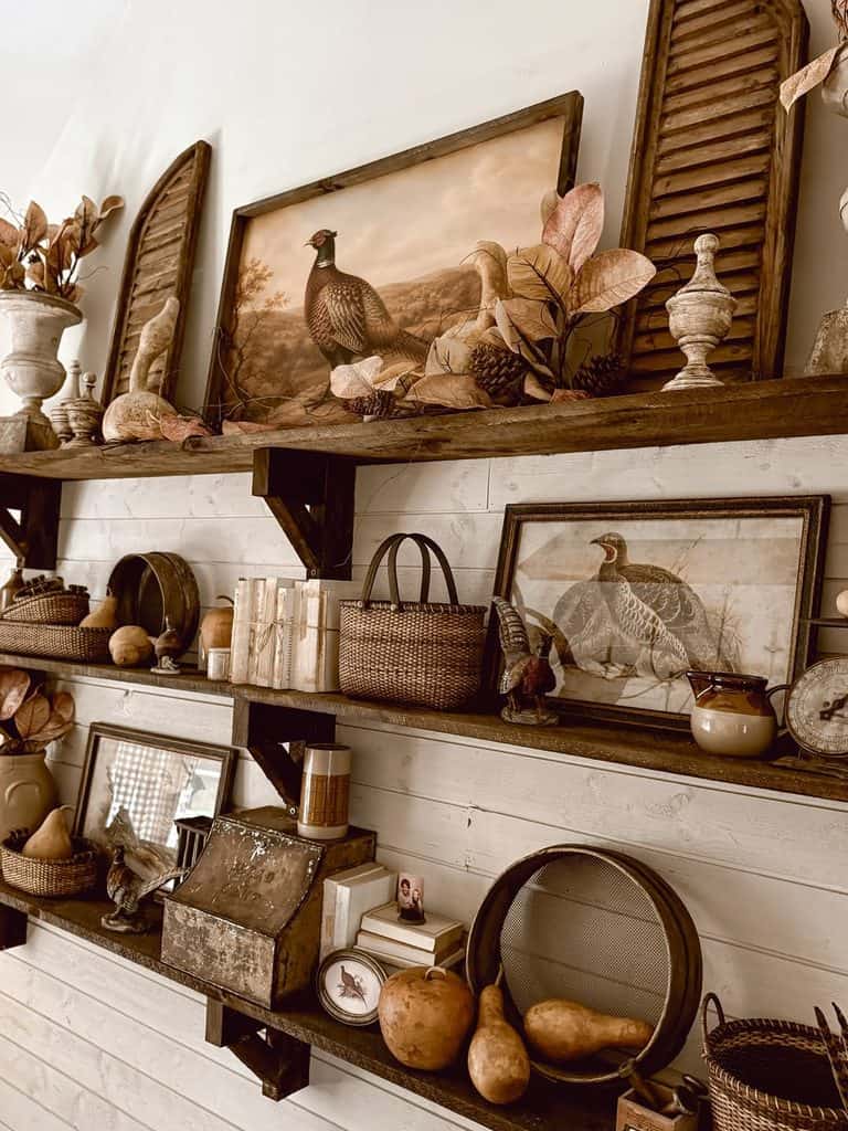 Rustic fall decor with pumpkins, feathers, and vintage accents at The Olive Branch Nest.