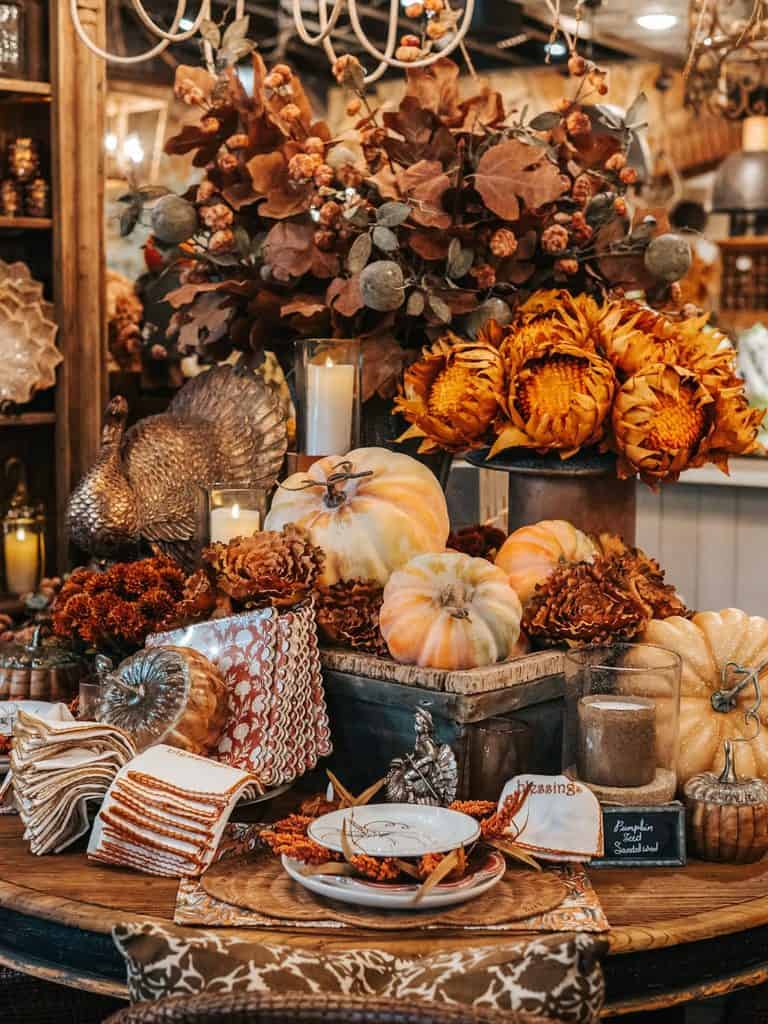 Fall decorating with pumpkins, dried leaves, candles, and rustic accents.