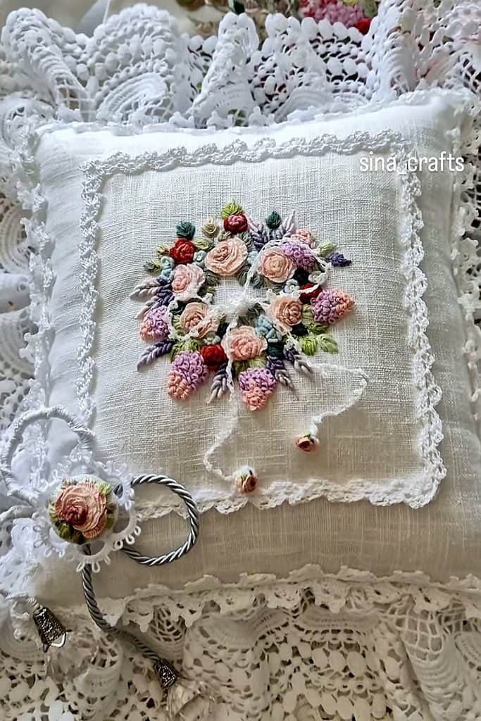 Elegant embroidered doily with colorful floral embroidery for home decor.