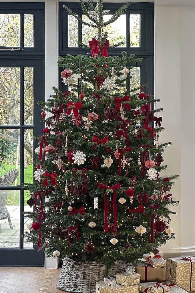 Beautiful Christmas tree decorated with red and white ornaments and ribbons.