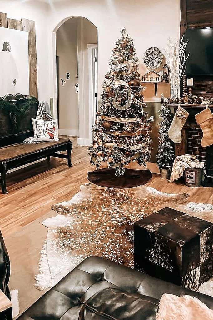 Decorated Christmas tree with ornaments and stockings in cozy living room.