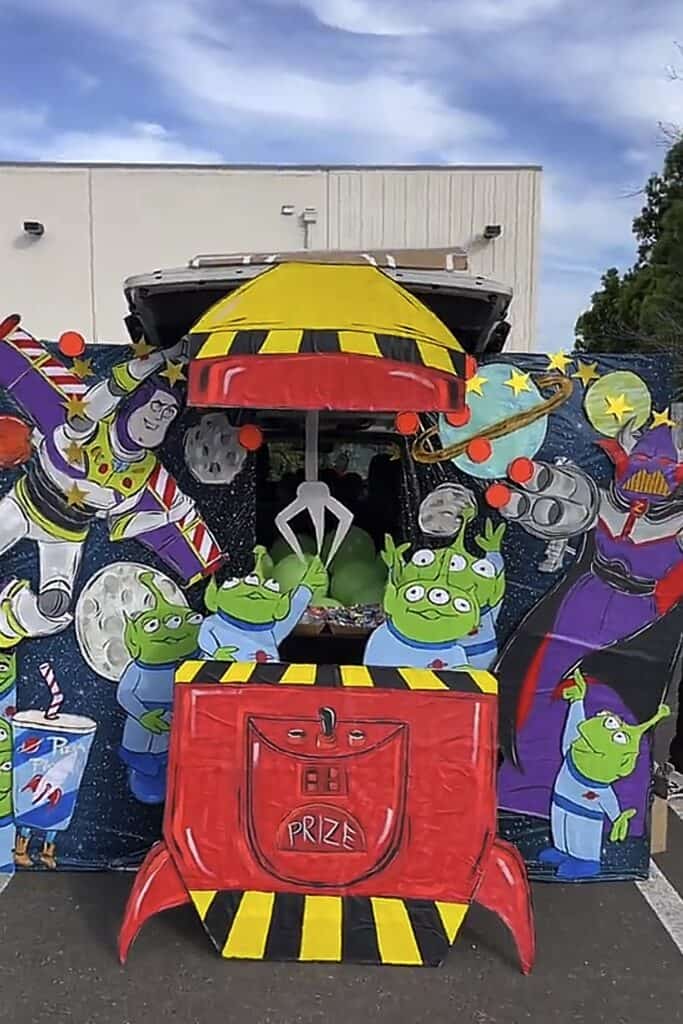 Colorful Toy Story themed trunk or treat display with characters and prizes.