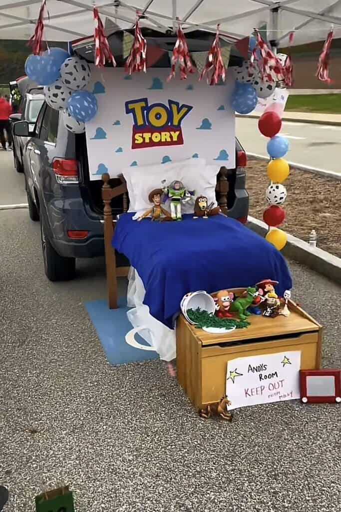 Toy Story themed trunk or treat setup with bed and decorations for Halloween.