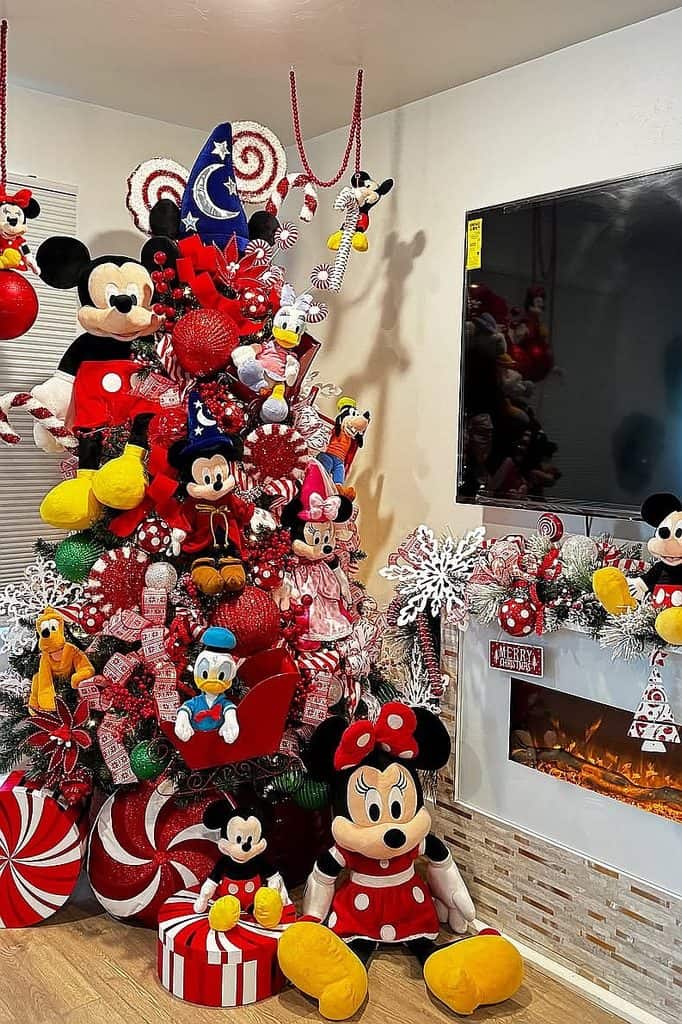 Festive Disney-themed Christmas tree with Mickey and Minnie plush toys and ornaments.
