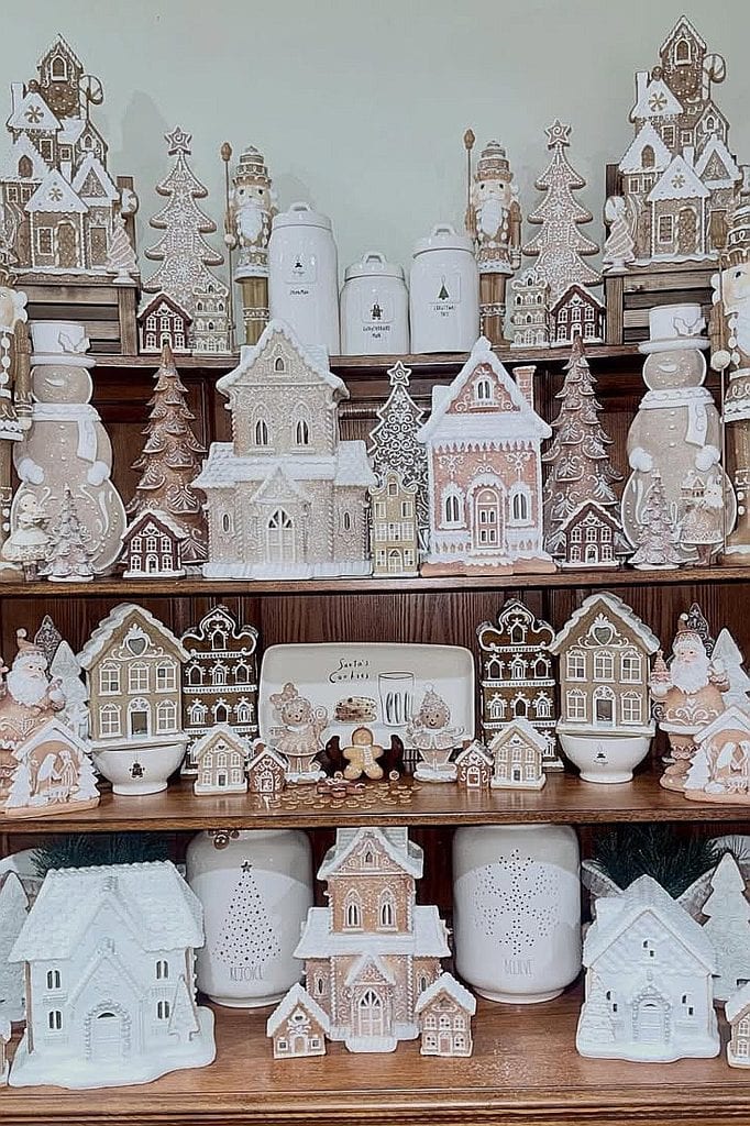Decorative Christmas village with gingerbread houses and snow-themed ornaments.