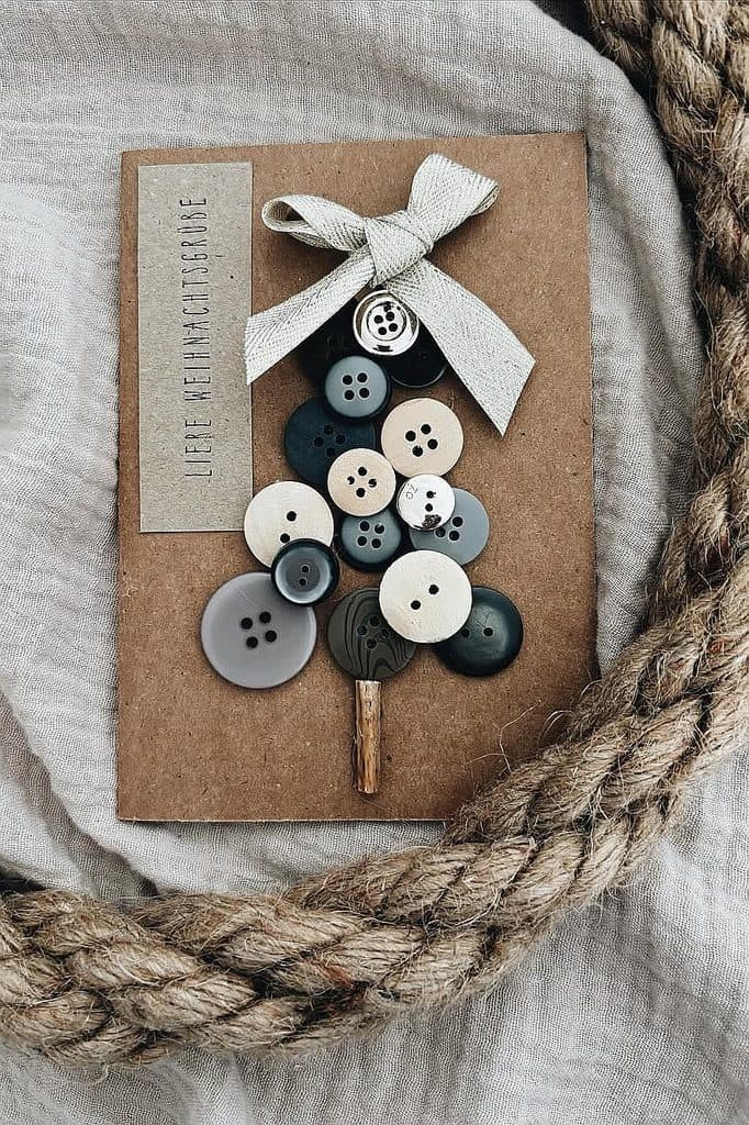 Decorative Christmas button craft with ribbon and stick for holiday decor.