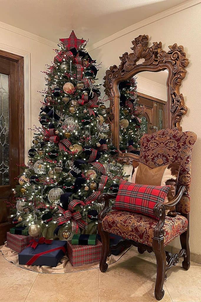 Festive Christmas tree decorated with red, black, and silver ornaments in a cozy room.