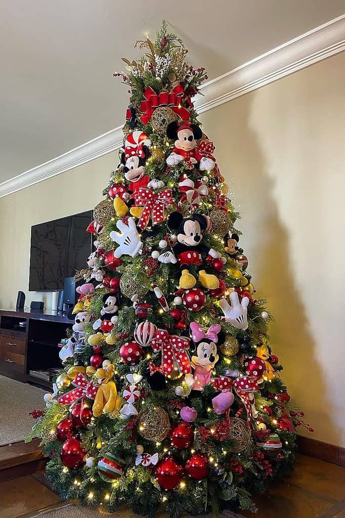 Festive Christmas tree decorated with Disney characters Mickey and Minnie Mouse ornaments.