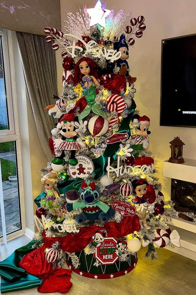 Festive Disney-themed Christmas tree with ornaments, characters, and holiday decor.