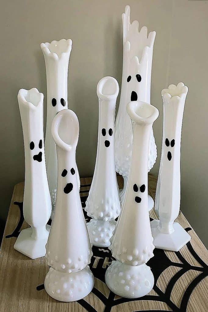 Set of white milk glass giraffe figurines with black spots, charming home decor.