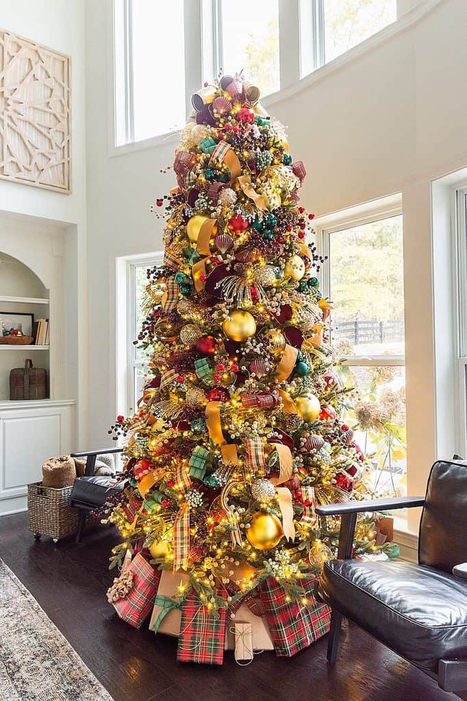 Colorful Christmas tree with gold, red, and green ornaments and presents.