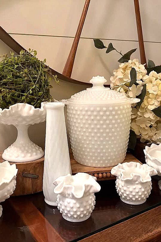 Elegant milk glass collection with vases and jars for home decor.