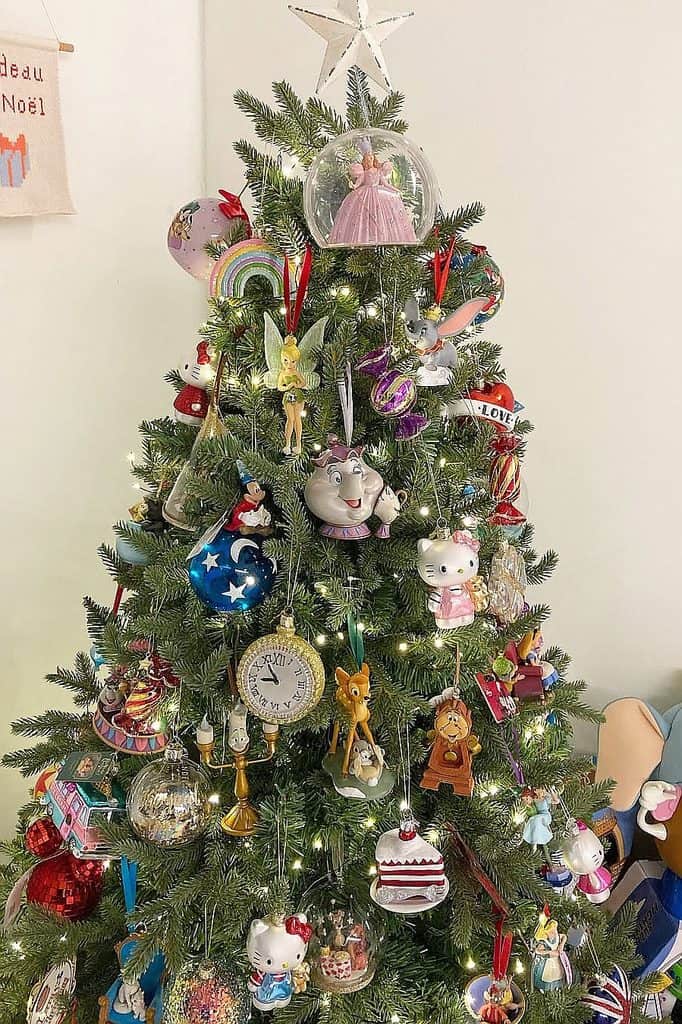 Festive Christmas tree decorated with Disney-themed ornaments and lights.