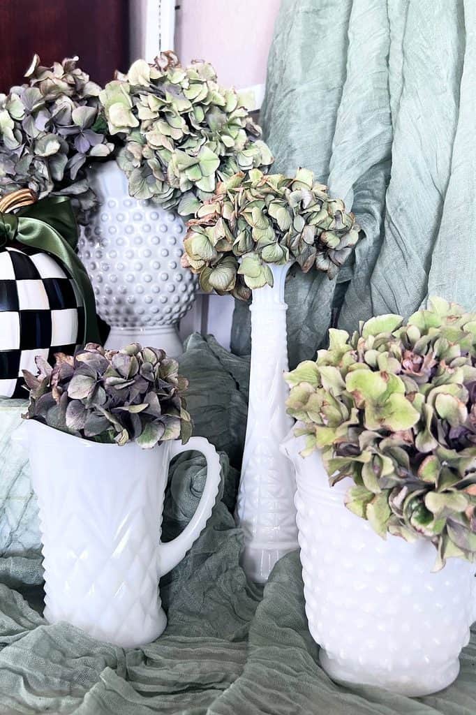 Charming milk glass vases with hydrangea flowers for home decor.