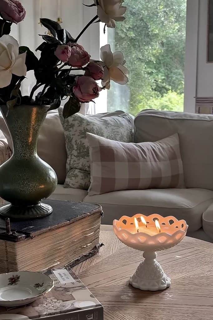 Charming living room with milk glass vase and floral arrangement.