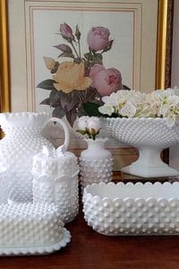 Elegant collection of white milk glass vases and bowls with floral artwork.