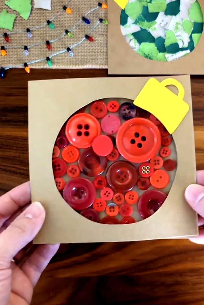 Creative Christmas button craft with red buttons in a circular box for holiday decor.