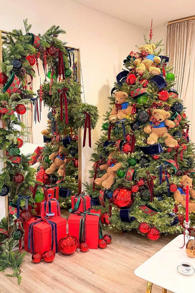 Decorated Christmas tree with teddy bears, ribbons, and ornaments for holiday decor.