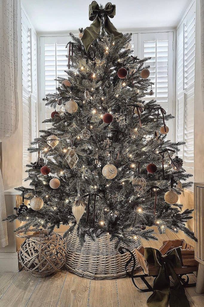 Decorated Christmas tree with ornaments and lights in a cozy home setting.