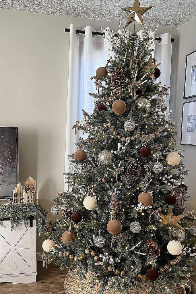 Elegant decorated Christmas tree with gold, silver, and brown ornaments in cozy home.