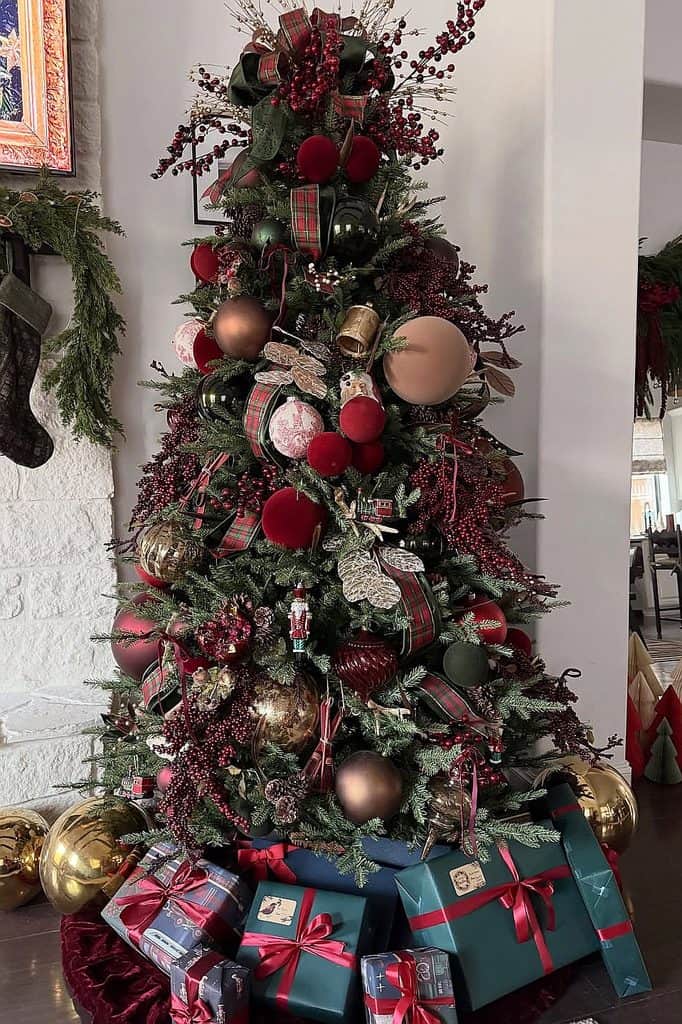 Festive Christmas tree decorated with red, gold, and plaid ornaments, surrounded by wrapped gifts.