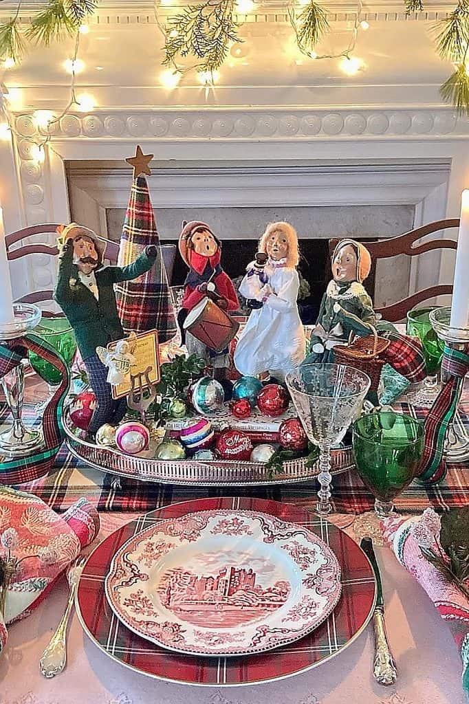 Festive Christmas table with elf, nutcracker, ornaments, and plaid accents.