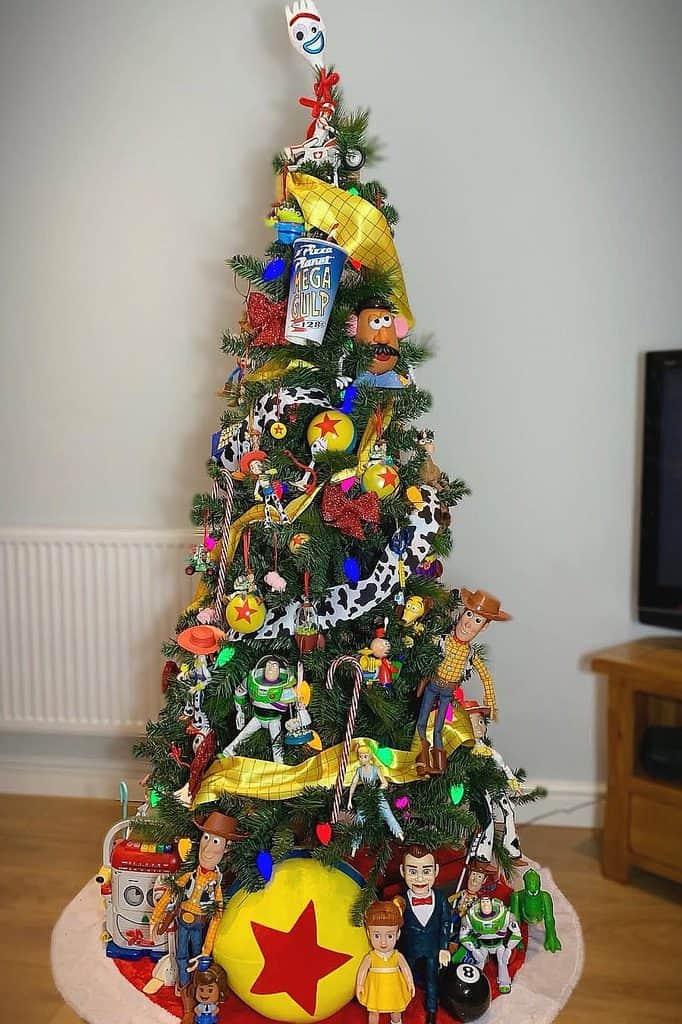 Colorful toy-themed Christmas tree with Woody, Buzz Lightyear, and Jessie from Toy Story.